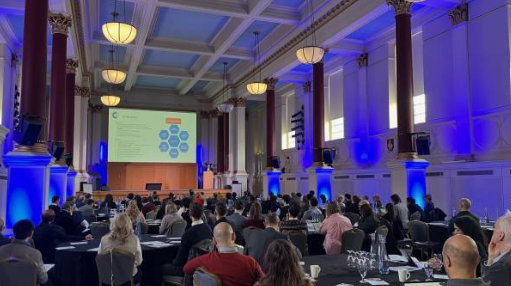 Conference audience seated in BMA House, London, watching a speaker present slides at the DTNet+ Launch Event on 17 January 2024